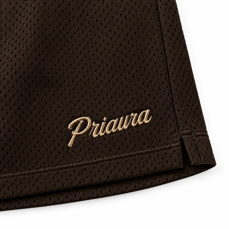 Gold Priaura script on the Espresso mesh shorts