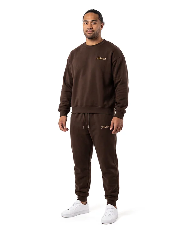 Model in the Espresso crewneck and joggers with the Priaura script in gold thread